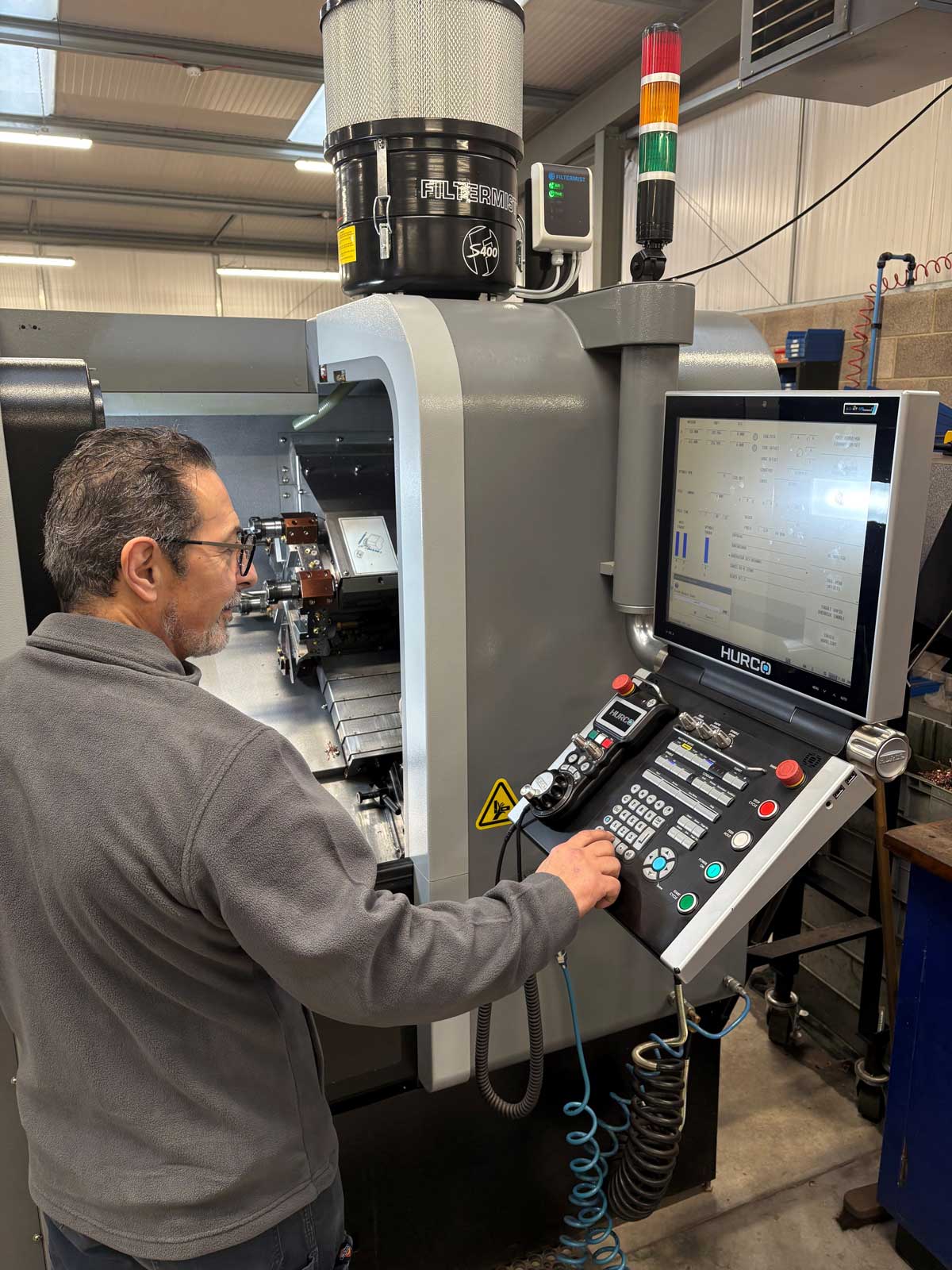 LML production member of staff operating the HURCO VM6i lathe